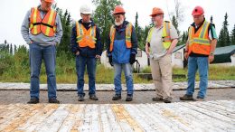 First Mining Finance president Patrick Donnelly (far left) looks over core samples with colleagues at the Springpole gold project, 110 km northeast of Red Lake, Ontario. Credit: First Mining Finance.