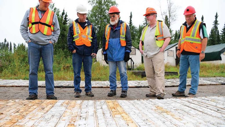 First Mining Finance president Patrick Donnelly (far left) looks over core samples with colleagues at the Springpole gold project, 110 km northeast of Red Lake, Ontario. Credit: First Mining Finance.