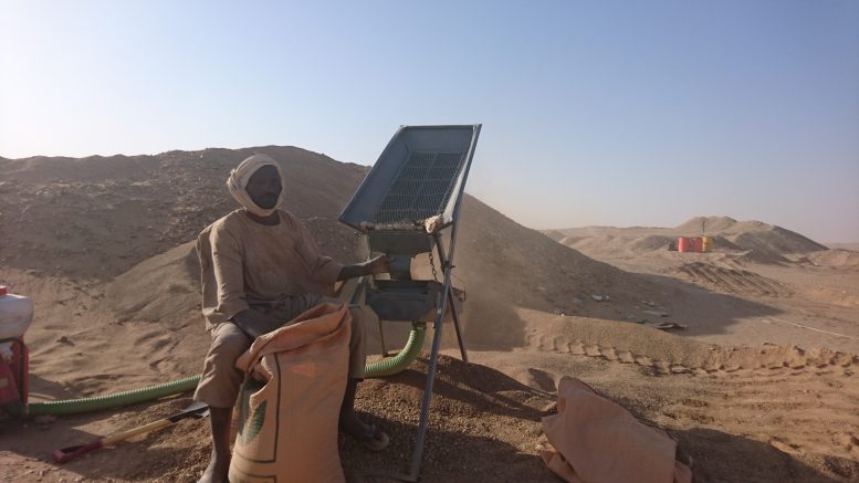 An artisanal miner sifts through rock for gold in the Nubian Desert. Photo by Richard Quarisa.