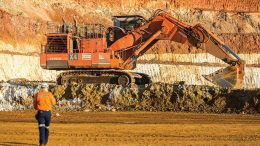 A worker walks towards an excavator and Glencore’s Murrin Murrin nickel-cobalt mine in Western Australia. Credit: Glencore.