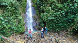 A stream sediment sampling crew planning its next move when confronted with a waterfall at Aurania Resources’ Lost Cities-Cutucu gold property area. Credit: Aurania Resources.