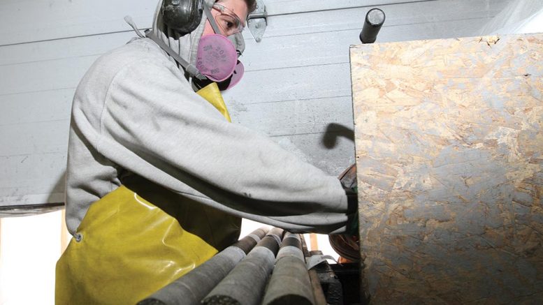 A worker cutting core at Nouveau Monde Graphite’s Matawinie project in Quebec, 120 km north of Montreal. Credit: Nouveau Monde Graphite.