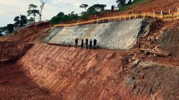 Workers stand near a batter under development to accommodate the primary crusher at Alphamin Resources’ Bisie tin project in the eastern Democratic Republic of the Congo. Credit: Alphamin Resources.