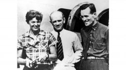 In this photo taken on or about July 2, 1937, American aviator Amelia Earhart (left) and her navigator Fred Noonan (right), pose beside their plane with gold miner F.C. Jacobs at Lae, New Guinea, just before Earhart and Noonan took off in a flight to Howland Island on July 2, during which they disappeared somewhere in the Pacific. Credit: AP.
