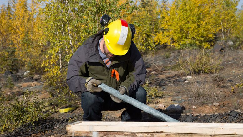 Nighthawk staff inspecting core samples at the Indin Lake gold property. Credit: Nighthawk.