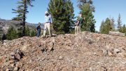 Crown Mining director George Cole (with hammer) and colleagues on an outcrop of the Moonlight copper deposit in eastern California’s Plumas County. Credit: Crown Mining.