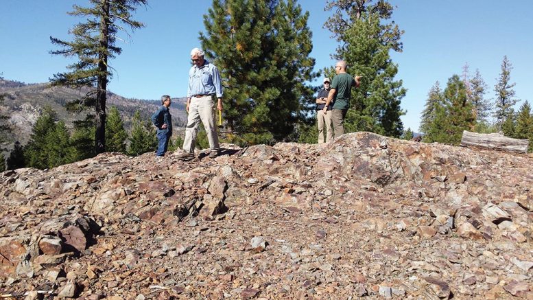 Crown Mining director George Cole (with hammer) and colleagues on an outcrop of the Moonlight copper deposit in eastern California’s Plumas County. Credit: Crown Mining.