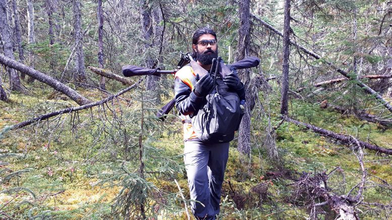 Pioneer Aerial Surveys’ field manager Andrew Gagnom-Nadram moves equipment related to the UAV magnetometer survey at Supreme Metals’ Bloom Lake East cobalt-iron ore project in Labrador. Credit: Pioneer Aerial Surveys.