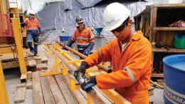 Drillers handle core at the Cascabel project. Credit: SolGold.